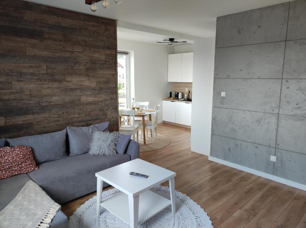 a living room with a couch and a table at Ustronny Zakątek in Ustroń