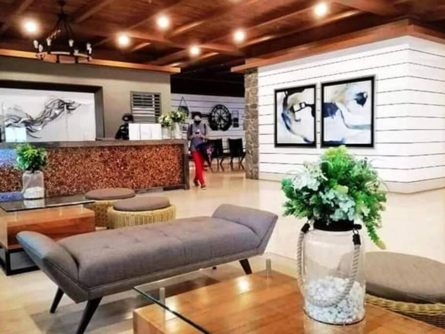 a living room with a couch and a table at C&C Cool View Tagaytay Staycation in Tagaytay