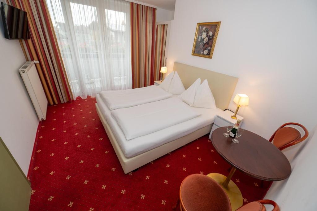 Postel nebo postele na pokoji v ubytování Pension & Apartments Ertl