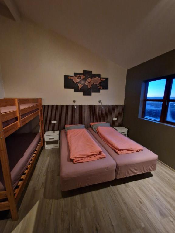 a bedroom with two bunk beds and a window at Eaglerock Guesthouse and tours in Kirkjubæjarklaustur