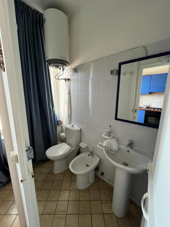 a bathroom with a toilet and a sink and a mirror at Matteo's House Taormina in Taormina