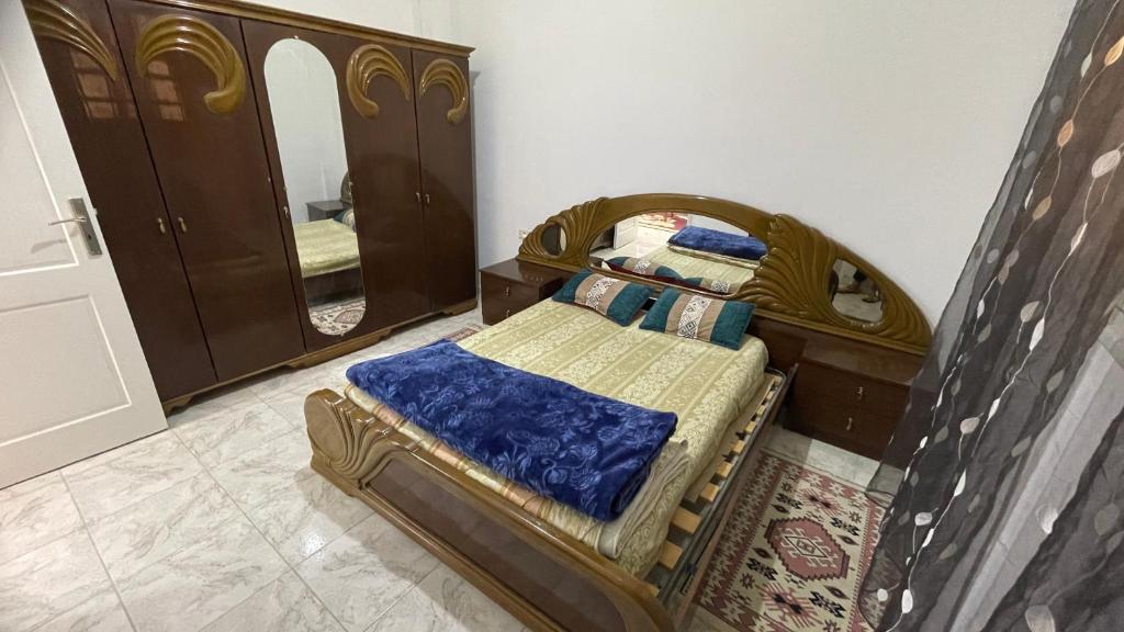 a bedroom with a bed and a mirror at Dar elrayen in Tozeur