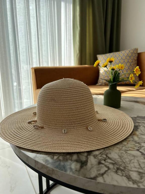 a straw hat sitting on a table in a living room at Art life apart (Meadow) in Alanya