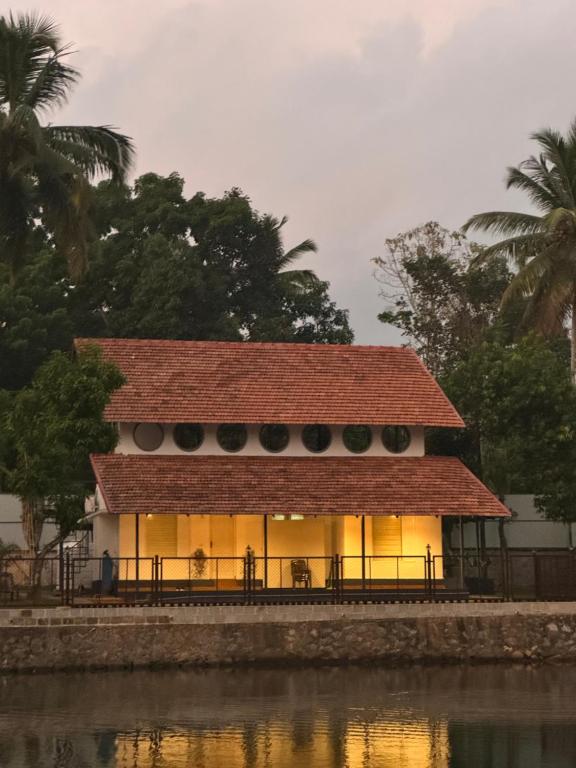 a building next to a body of water at Blue Lake Villa in Kollam