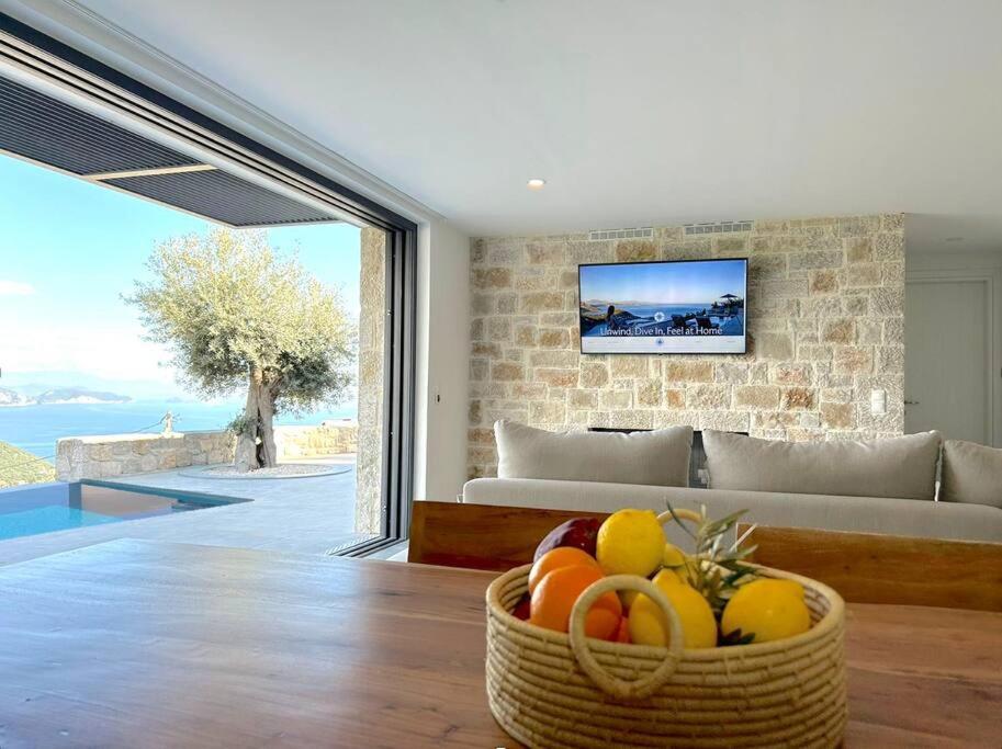 a basket of fruit in a living room with a couch at Go-Blue Star, Villa Sea in Sivota