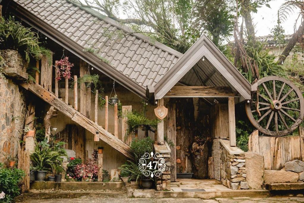 a wooden house with a wooden wheel in front of it at Villa 47 in Nuwara Eliya