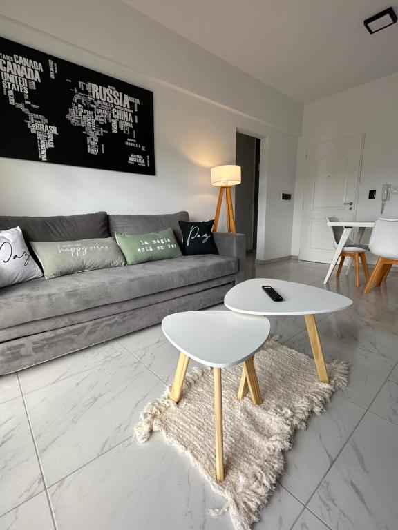 a living room with a couch and a table at Patagonia House - Mayo in Puerto Madryn