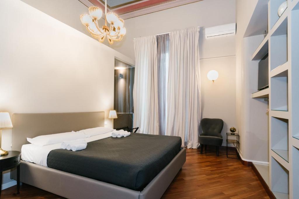A bed or beds in a room at Duomo Housing Catania Le Suites