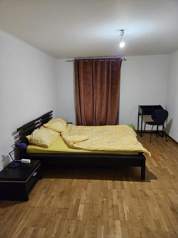 ein Schlafzimmer mit einem Bett in einem Zimmer mit einem Fenster in der Unterkunft Standard room in La Chaux-de-Fonds