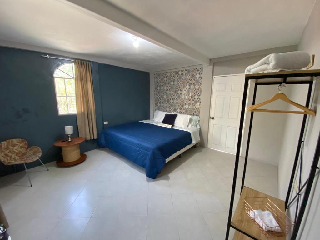 a bedroom with a blue bed and a window at Habitación cerca del aeropuerto #2 in La Paz