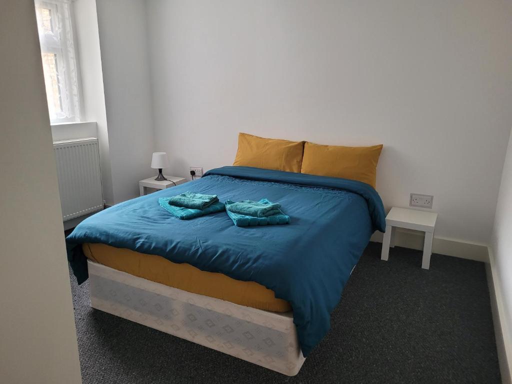 a bedroom with a bed with two towels on it at Lovely 2-Bed fully refurbished House in London in London