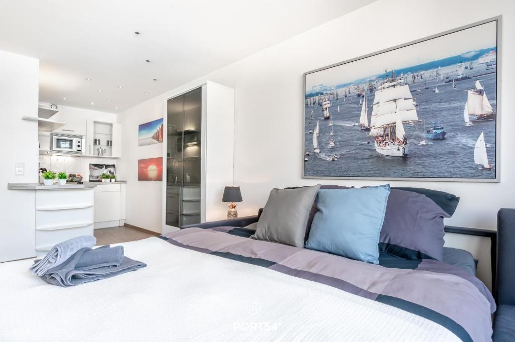 a bedroom with a bed with a large painting on the wall at Ferienwohnung Marina Apartment 9403 in Marina Wendtorf in Wendtorf