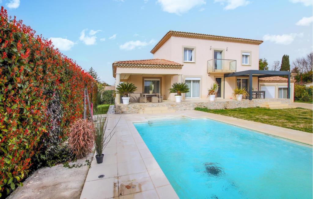 a villa with a swimming pool in front of a house at Beautiful Home In Sauveterre With Private Swimming Pool, Can Be Inside Or Outside in Sauveterre