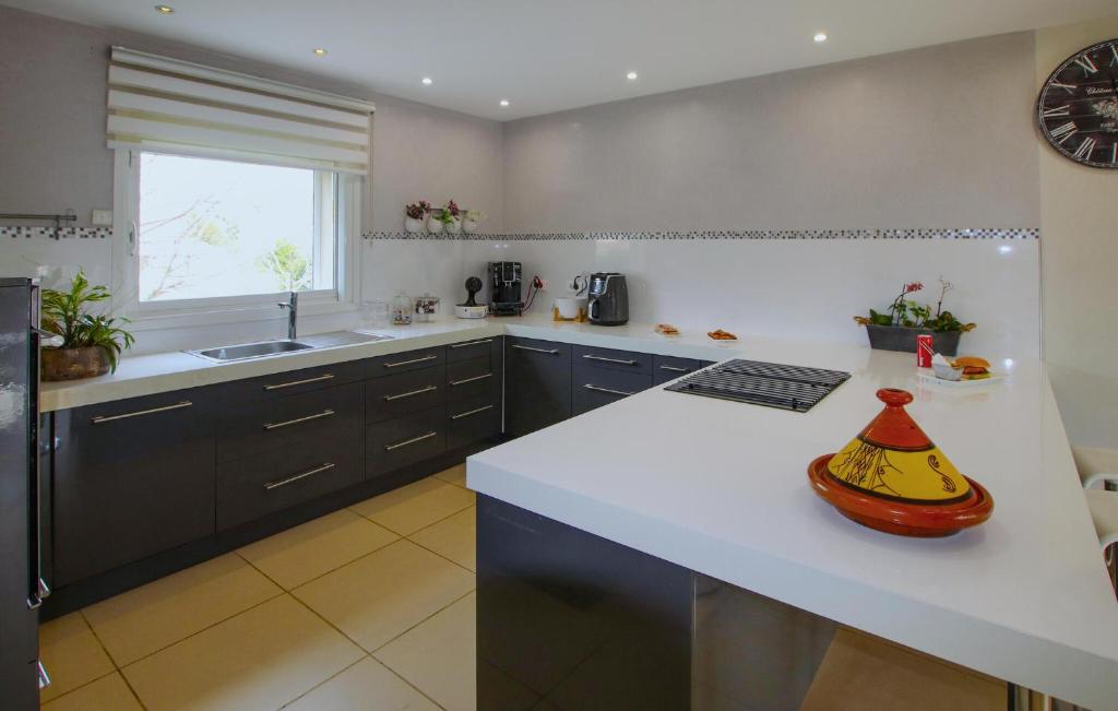 a kitchen with a counter with a banana on it at Beautiful Home In Sauveterre With Private Swimming Pool, Can Be Inside Or Outside in Sauveterre