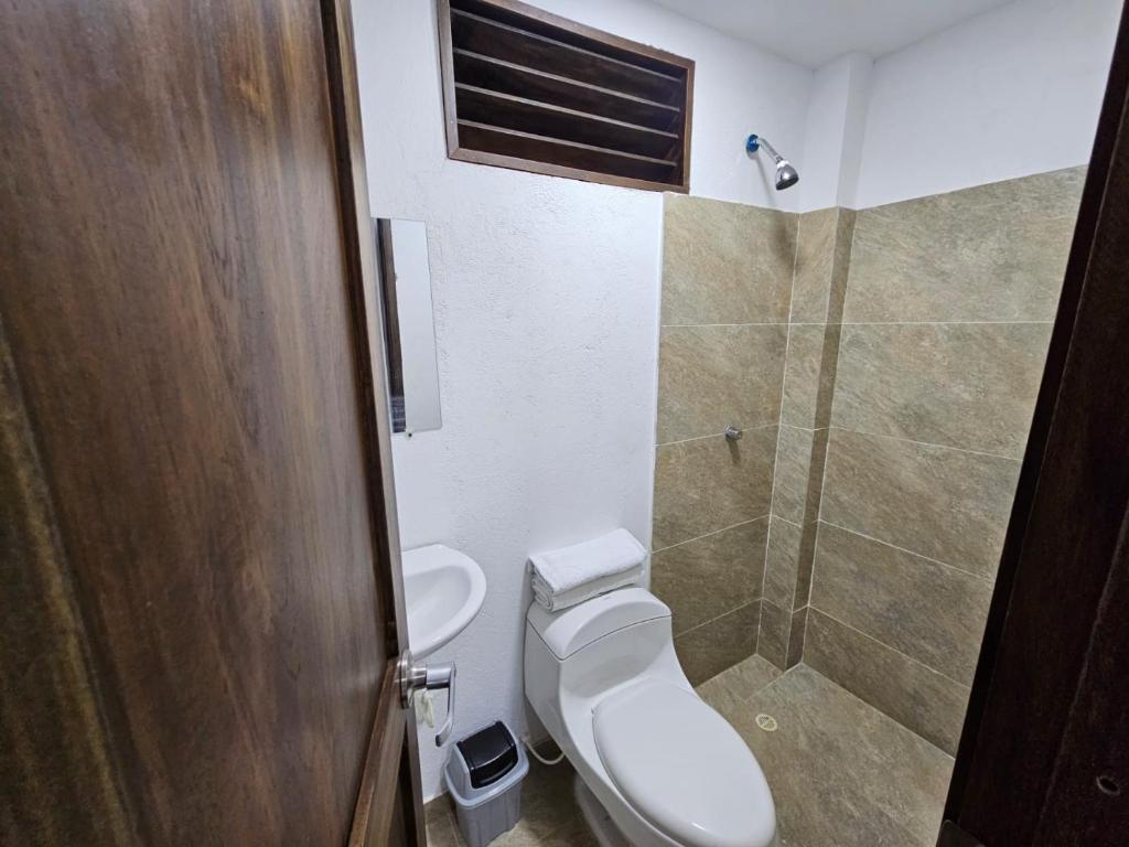 a bathroom with a toilet and a shower at Hotel Victoria Queen Villavieja in Villavieja