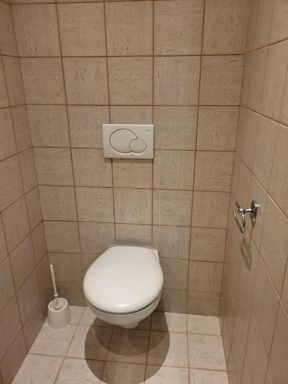 a bathroom with a white toilet in a stall at Sunfower Prague Suites in Prague
