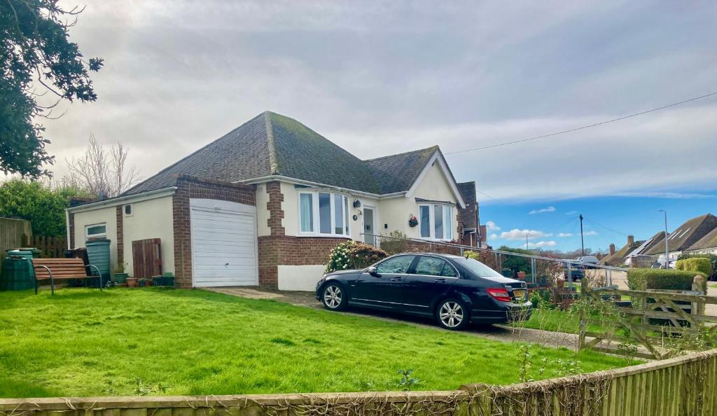 a blue car parked in front of a house at Mariners Corner in Bexhill