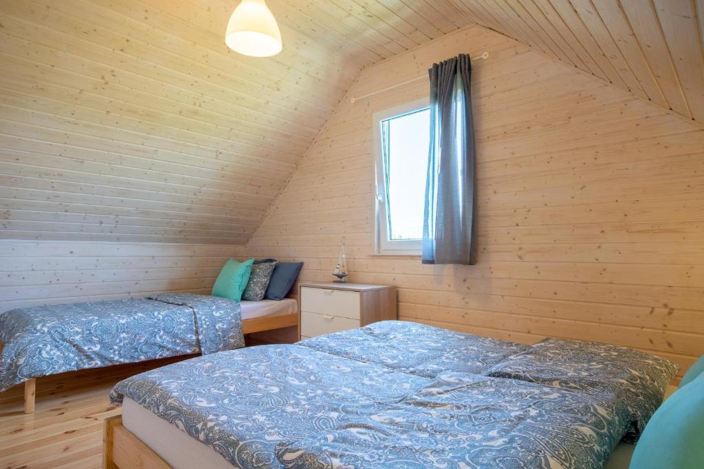 Postel nebo postele na pokoji v ubytování Osada Skandia Kopań
