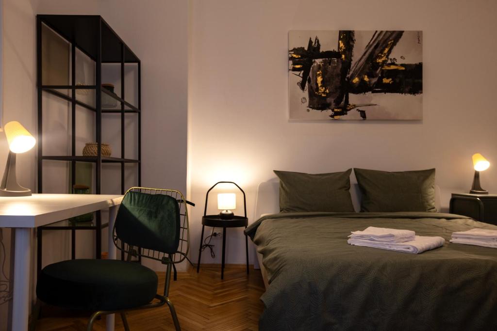 a bedroom with a bed and a desk and a table at Ultracentral Hong Kong 3 Bdrm apartment in Bucharest