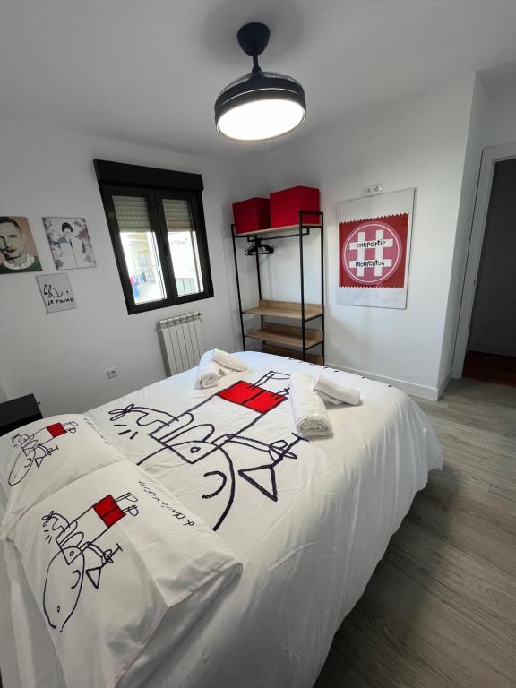 ein Schlafzimmer mit einem weißen Bett mit Zeichnungen darauf in der Unterkunft VIVIENDA DE USO TURÍSTICO ENJOY ÁVILA 4- DIVINO in Avila