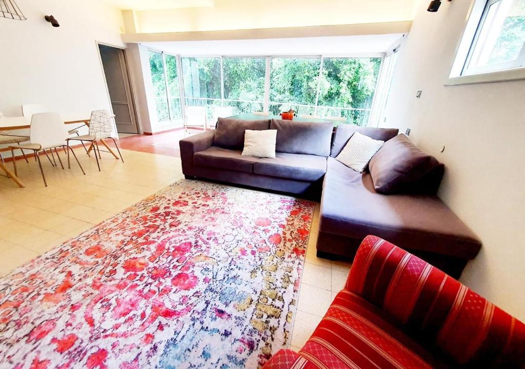 a living room with a couch and a rug at Super Spacious 2BD Habima TLV heart, Balcony & Parking in Tel Aviv