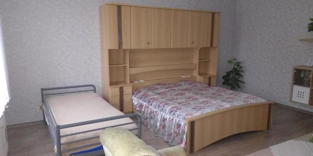 a small bedroom with a bed and a chair at Ferienwohnung Mantei in Altentreptow