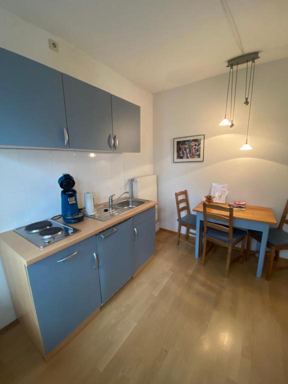 a kitchen and dining room with a table and a kitchen and a kitchen at No.5 - Apartmenthaus in Stein in Stein