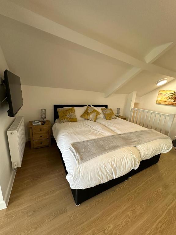 a bedroom with a large bed and a tv at The Highmead in Blackwood