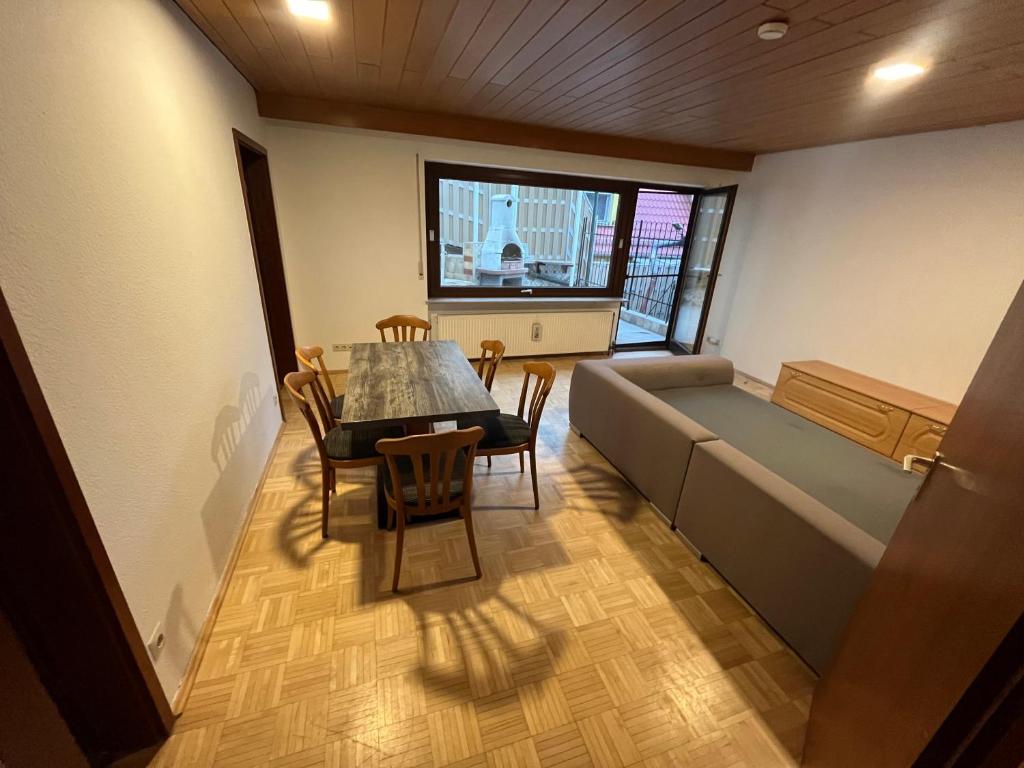 a dining room with a couch and a table and chairs at Ferienzimmer in Bad Mergentheim-Wachbach in Bad Mergentheim