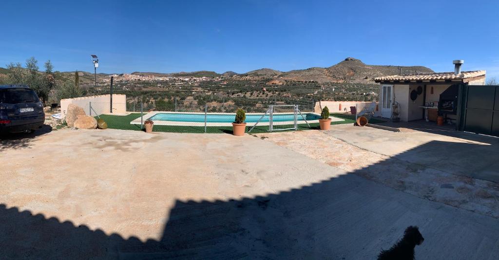a shadow of a dog standing in front of a pool at Casa la Umbría in Elche de la Sierra