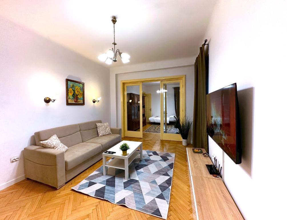 a living room with a couch and a table at Ultracentral Apartment 4 rooms - Old City Center -120 square meters - in Bucharest
