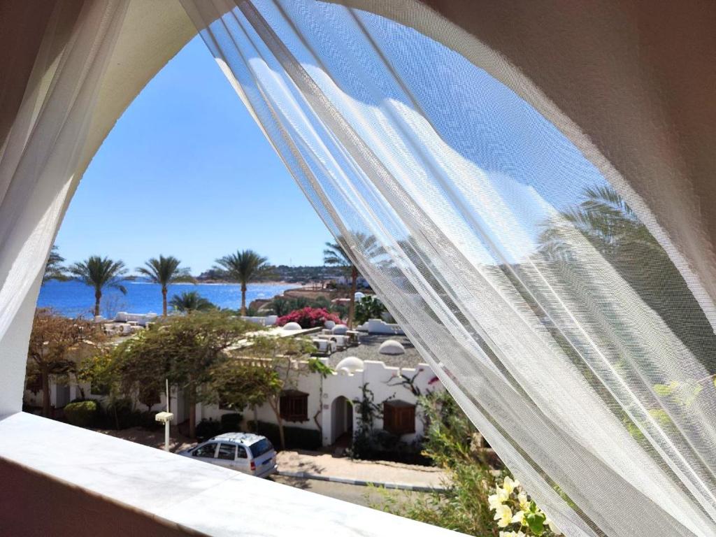 a window with a view of a city and the ocean at Domina Coral Bay in Sharm El Sheikh