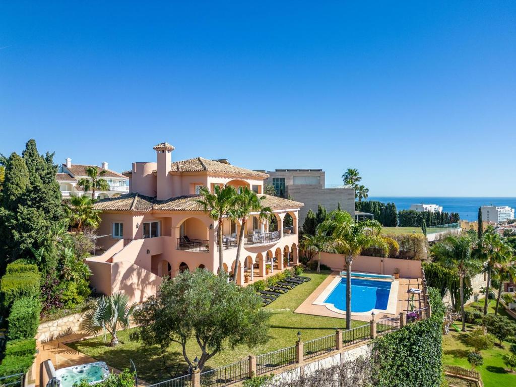 an aerial view of a villa with a swimming pool at Beachside villa with panoramic sea views in Benalmádena