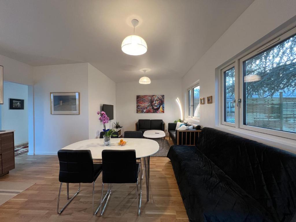 a living room with a table and a couch at Lyngby NO SMOKING Apt in Kongens Lyngby
