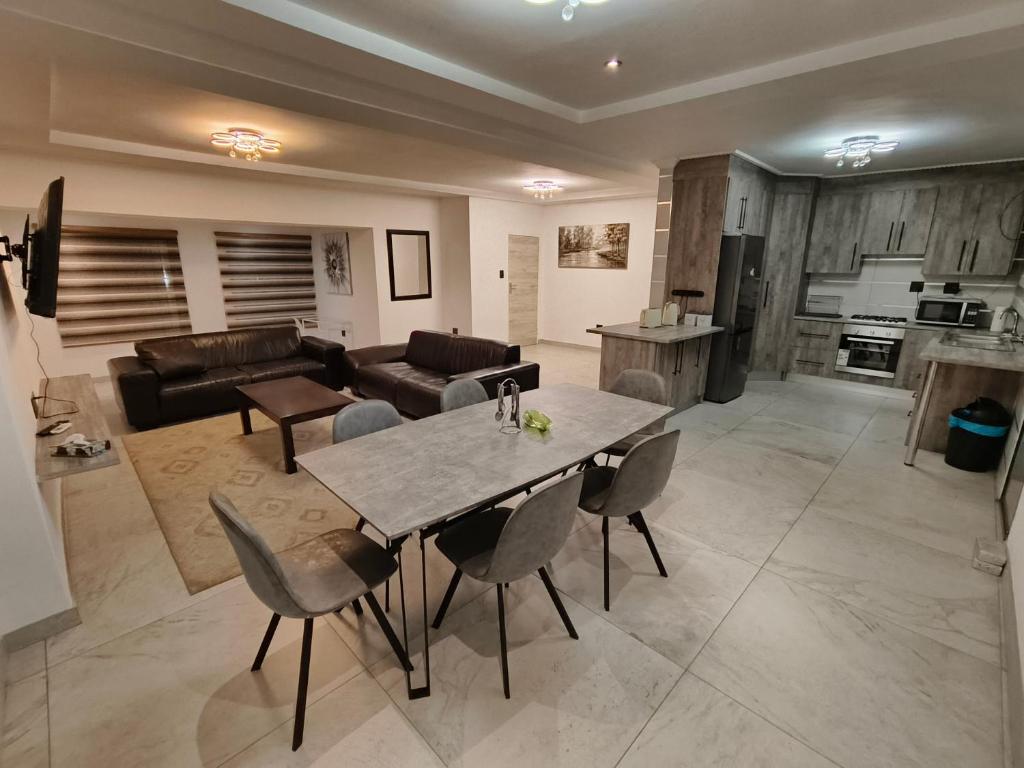 a large living room with a table and chairs at In Town Vaal in Vereeniging