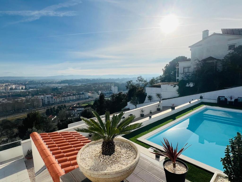a villa with a swimming pool on a roof at Vila Pombal Tomar Apartments - Pool & City Views in Tomar