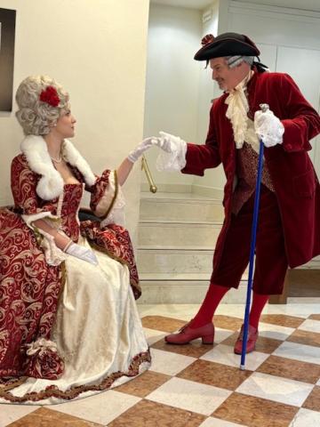 a man and woman dressed in costumes standing next to a woman at Locanda del Ghetto in Venice