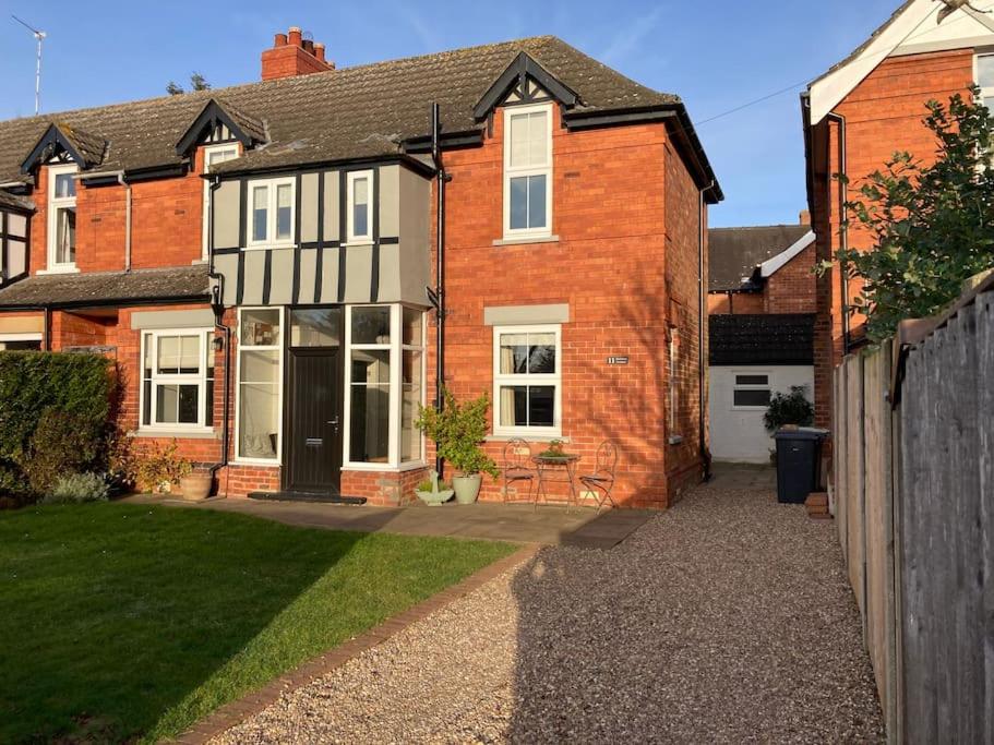 a red brick house with a black and white house at 11 T @ Woodhall Spa in Lincolnshire