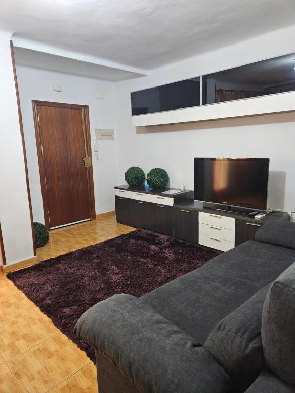 A television and/or entertainment centre at Vivienda con fines turísticos ALMA
