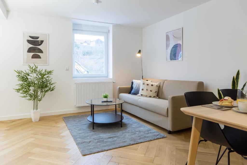 a living room with a couch and a table at Adler Apartments Sasbachwalden in Sasbachwalden