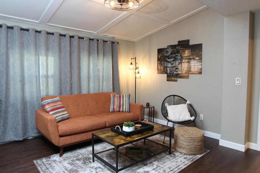 a living room with a couch and a table at The Nest Downtown Dunedin NO KIDS, NO PETS in Dunedin