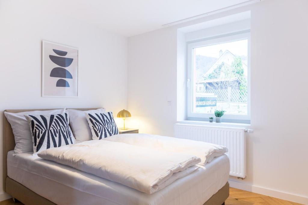 Postel nebo postele na pokoji v ubytování living TIMELESS - Adler Apartments Sasbachwalden