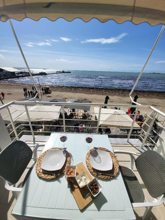 a table on the back of a boat on the beach at Alex's Apartment 2 in Durrës