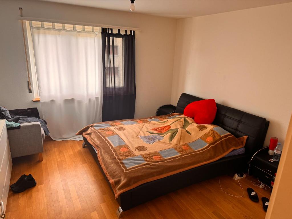 a bedroom with a bed with a blanket on it at Apartament Meisenweg in Biel