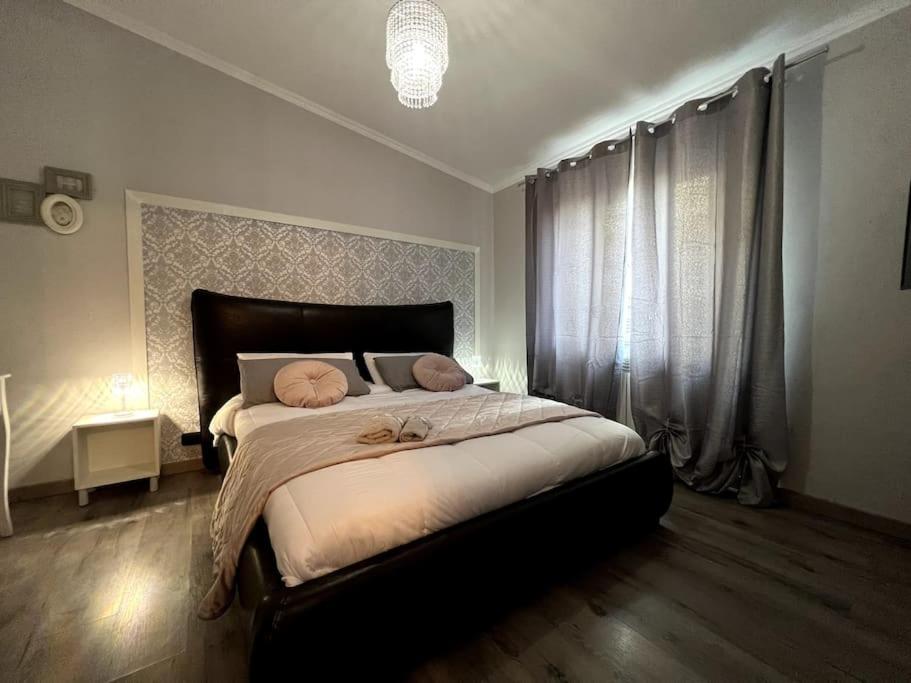 a bedroom with a large bed with two pillows on it at Casetta Valderoa Fiumicino in Fiumicino