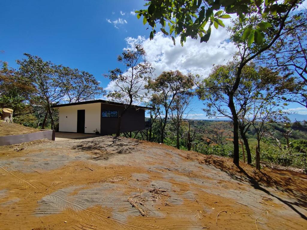 a small building on top of a dirt hill at El Paraíso Escondido in San Juan