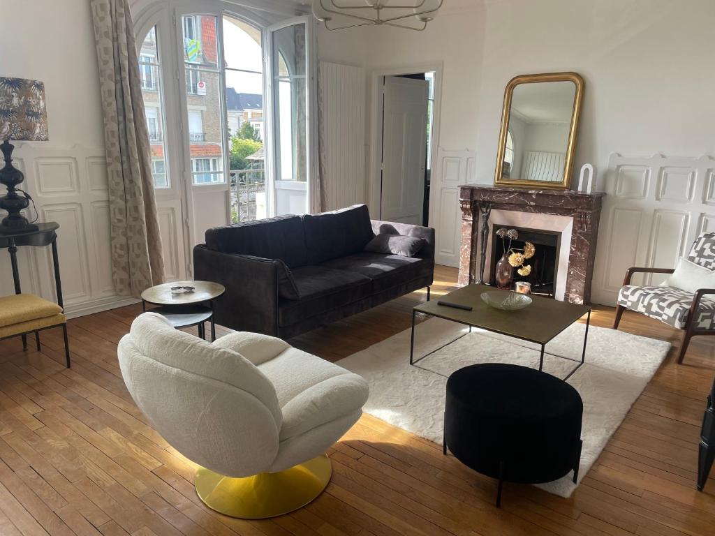 un salon avec un canapé et une chaise dans l'établissement L’Appartement de la Passerelle, à Soissons