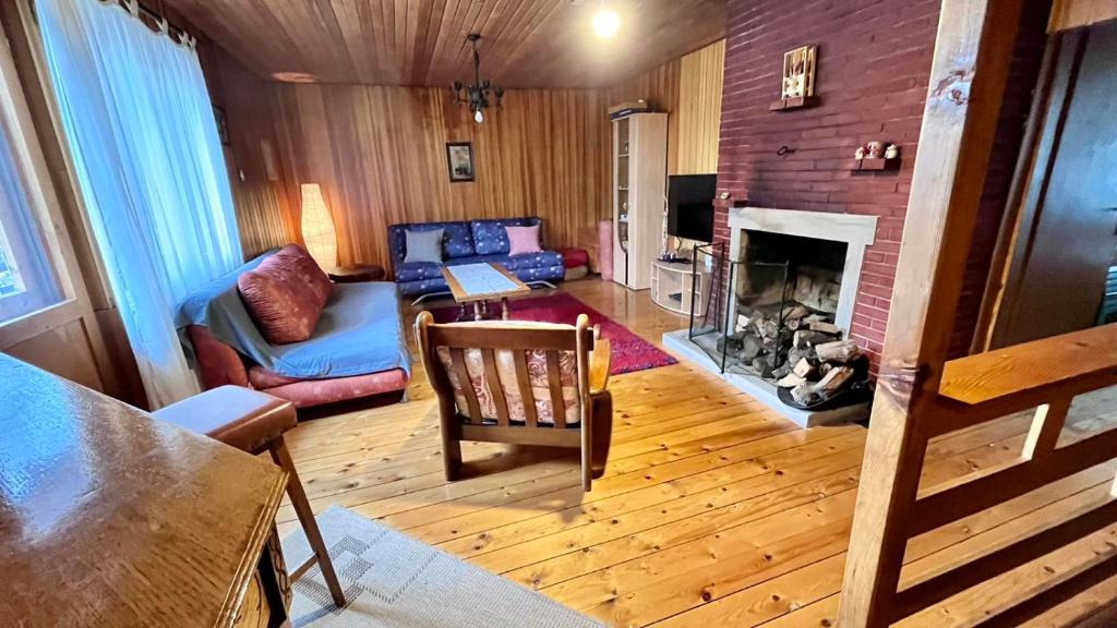a living room with a couch and a fireplace at Jahorina Villa Krila in Jahorina