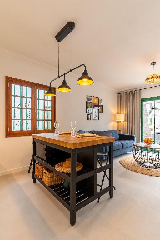 a kitchen with a island in the middle of a living room at Casa Narnia in Puerto del Carmen