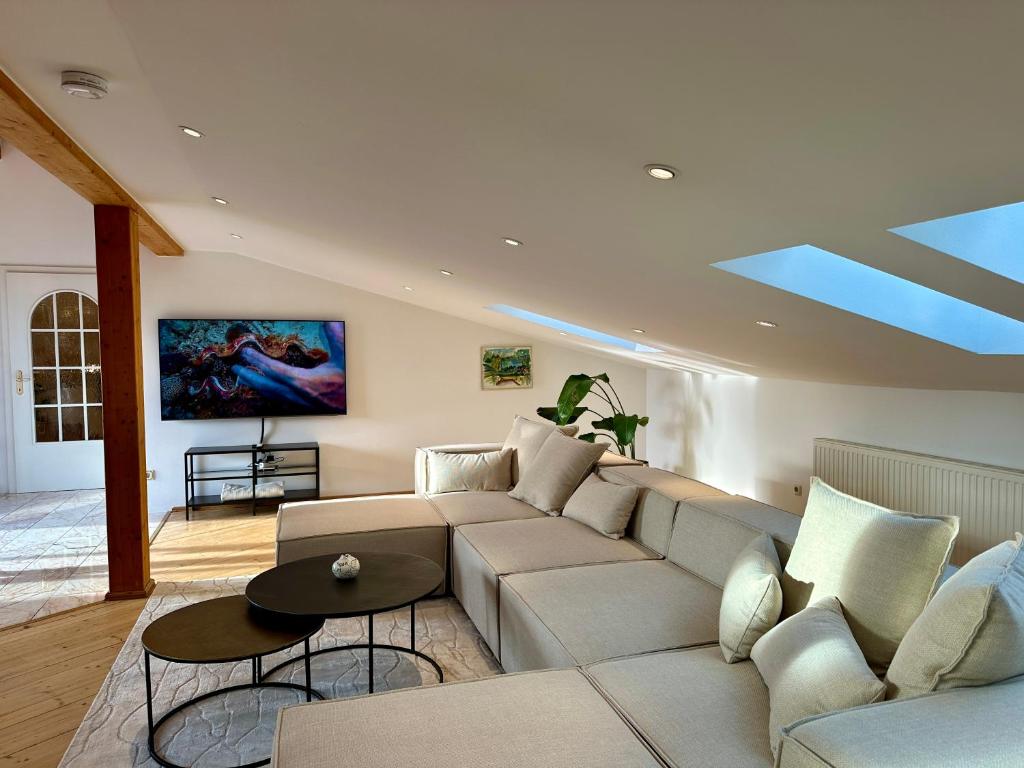 a living room with a couch and a table at 17er Apartment mit Sauna und Garage in Mondsee
